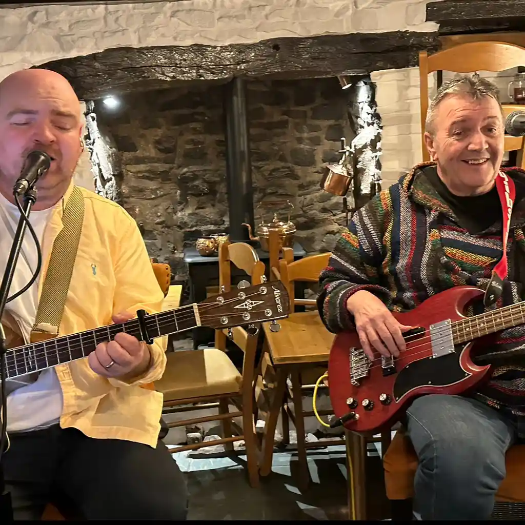 Two musicians performing inside The Horse and Jockey